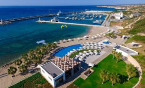 Swimming pool and marina in the distance taken from the air