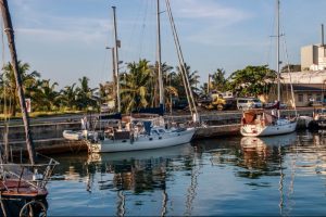 yachts moored next to a wharf in a harbour