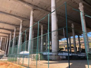 Yachts on a covered hardstanding beneath a motorway 