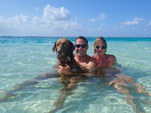 chloe the dog with her 2 owners and fellow crew members in the sea together