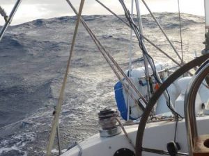 Picture of big ocean swells astern of a yacht.